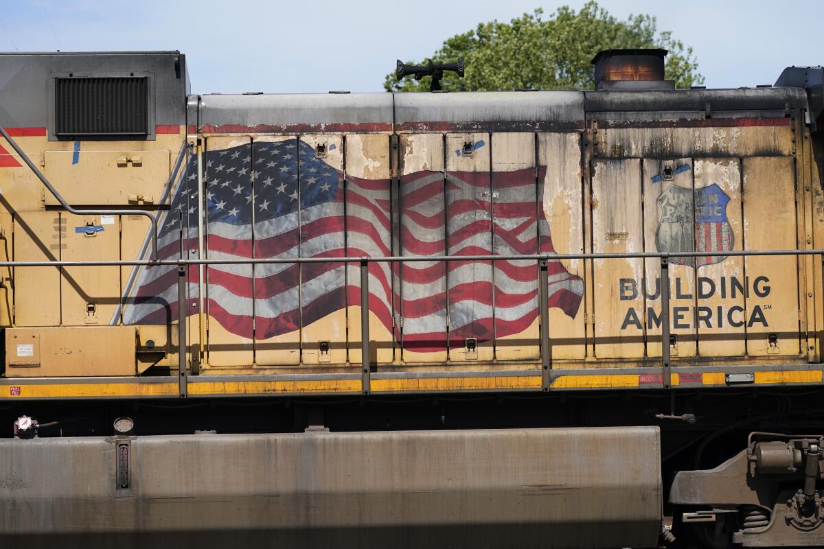 FILE - An American flag is emblazoned on this Union Pacific Railroad locomotive sitting in the Jackson, Miss., terminal rail yard, Wednesday, April 20, 2022. Union Pacific's second-quarter profit improved a bit, but the railroad's expenses jumped as it tried to reduce the delivery delays that have left its customers waiting for trains at times. The railroad said Thursday, July 21, that its profit grew 2% to $1.84 billion, or $2.93 per share. (AP Photo/Rogelio V. Solis, File)