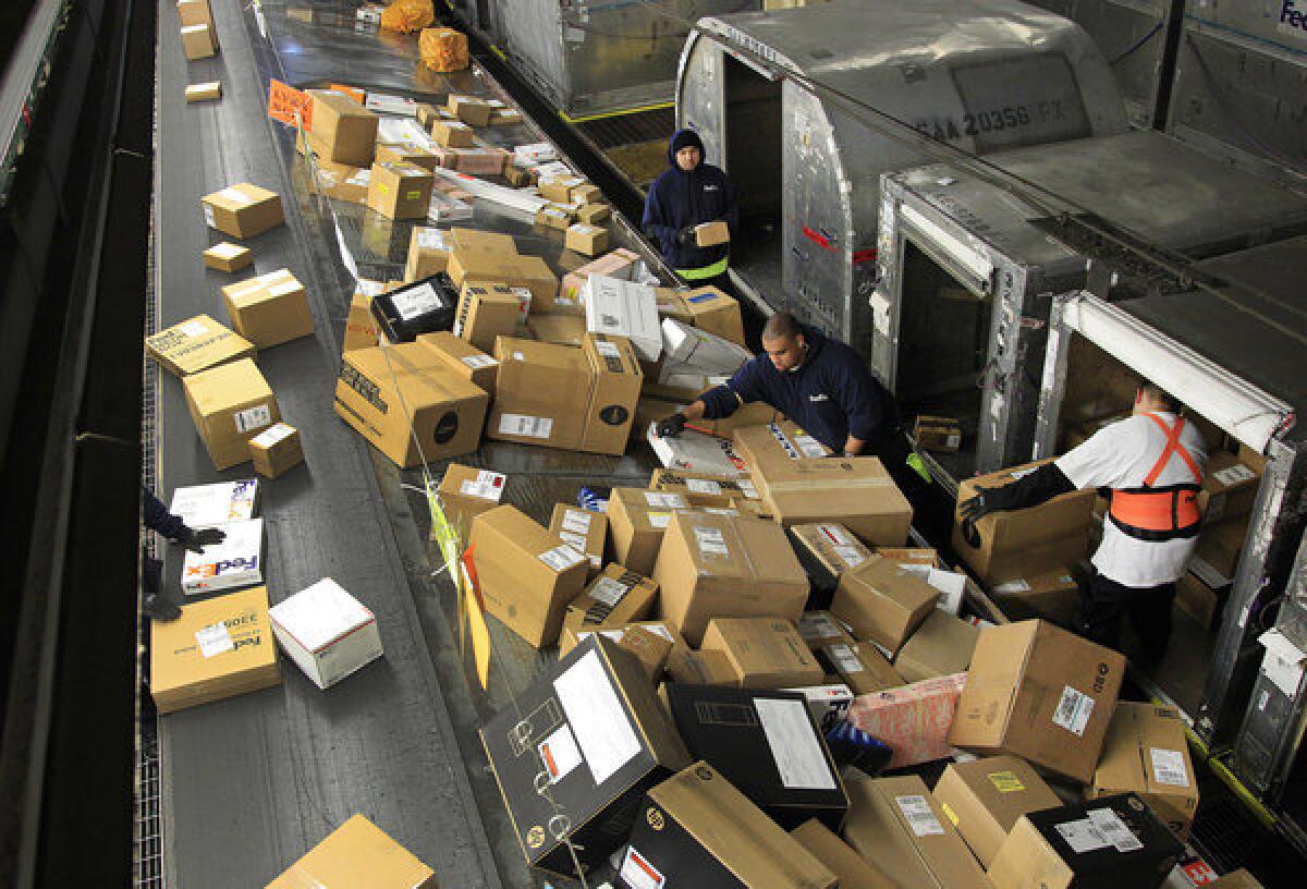 FedEx workers sort packages at the Oakland Regional Sort Facility on Dec. 11. Free Shipping Day is Monday, Dec. 17.