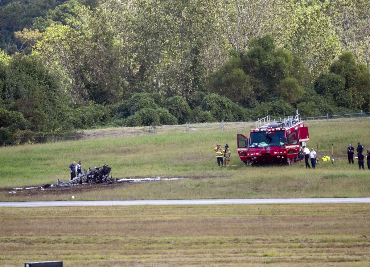 Emergency Response teams work the scene of a fatal small plane crash at DeKalb-Peachtree Airport, Friday, Oct. 8, 2021, in DeKalb County, Ga. (Alyssa Pointer/Atlanta Journal-Constitution via AP)