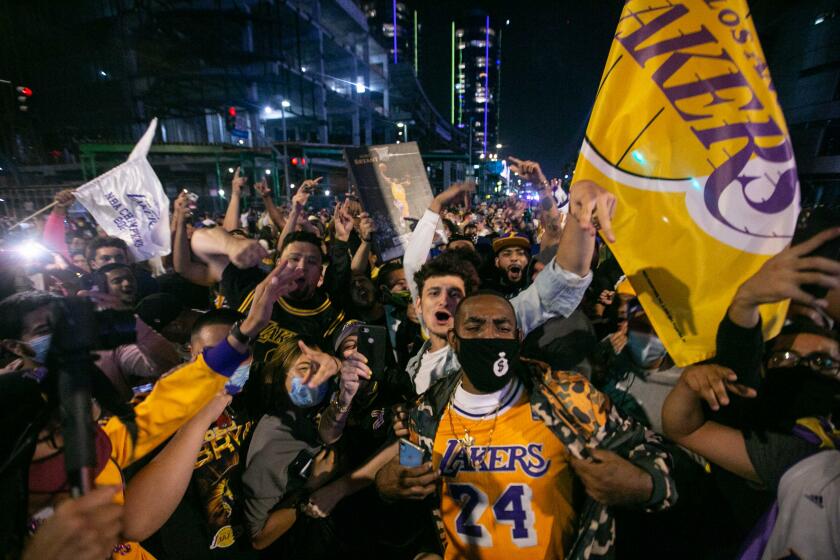 LOS ANGELES, CA - OCTOBER 11: Los Angeles Lakers fans gather near the Staples Center to celebrate the Lakers 106 - 93 game 6 over the Miami Heat on Sunday, Oct. 11, 2020 in Los Angeles, CA. (Jason Armond / Los Angeles Times)