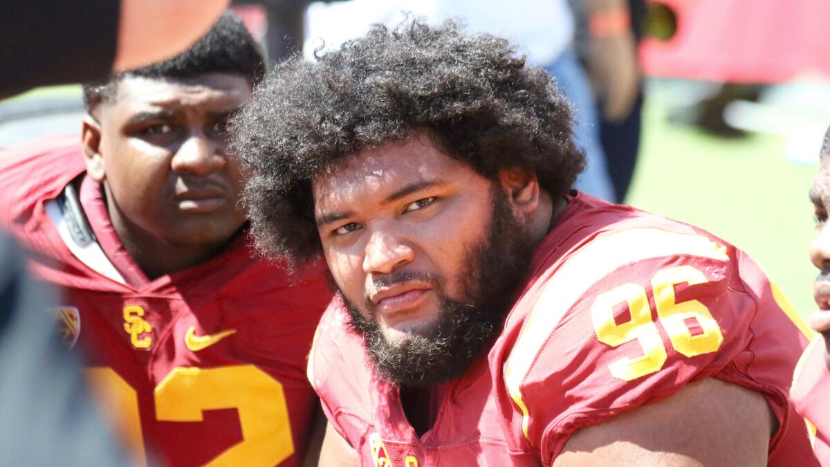 Defensive lineman Stevie Tu'ikolovatu watches from the bench in the second half of USC's 45-7 win over Utah State on Sept. 10.