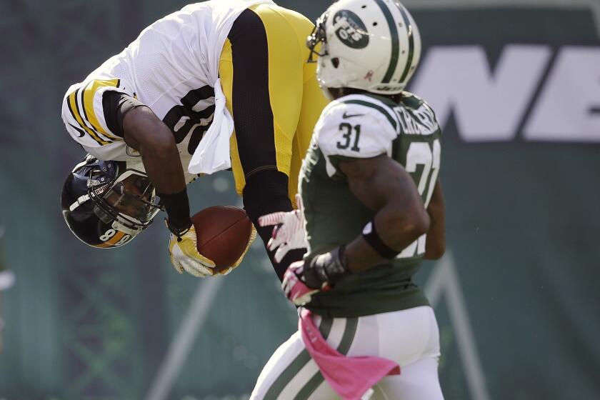 Pittsburgh's Emmanuel Sanders flips into the end zone for a touchdown in front of New York Jets' Antonio Cromartie on Sunday.