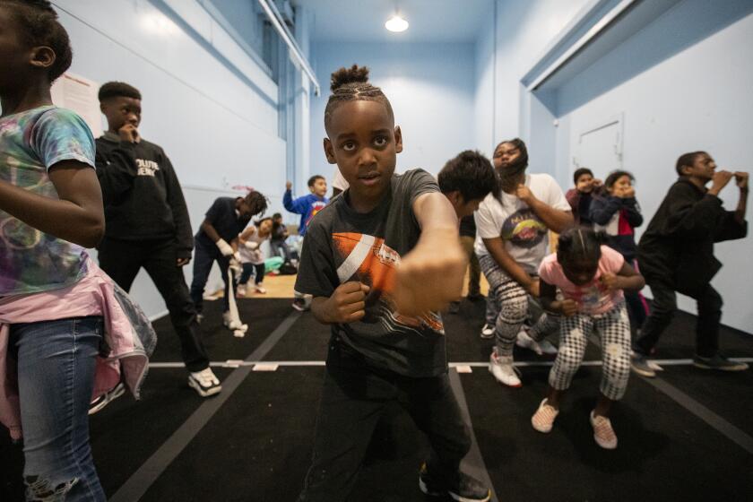 LOS ANGELES, CALIF. -- THURSDAY, NOVEMBER 21, 2019: Kids participate in a new boxing program at Nickerson Gardens in Watts, a program designed to show at-risk kids a different path in Los Angeles, Calif., on Nov. 21, 2019. One of the goals of the Nickerson Gardens Boxing Academy is to encourage physical and mental toughness. But, more importantly, organizers say its mission is to show children a different path. (Brian van der Brug / Los Angeles Times)