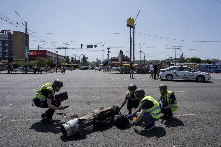Ukrainian Police officers inspecting a fragment of the rocket after a Russian rocket attack in Kyiv, Ukraine, Monday, May 29, 2023. Explosions have rattled Kyiv during daylight as Russian ballistic missiles fell on the Ukrainian capital. The barrage came hours after a more common nighttime attack of the city by drones and cruise missiles. (AP Photo/Evgeniy Maloletka)