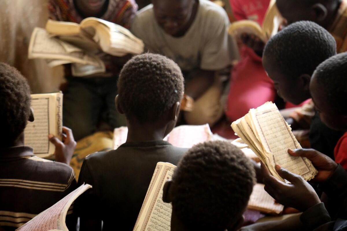 Talibes read the Quran in Dakar.