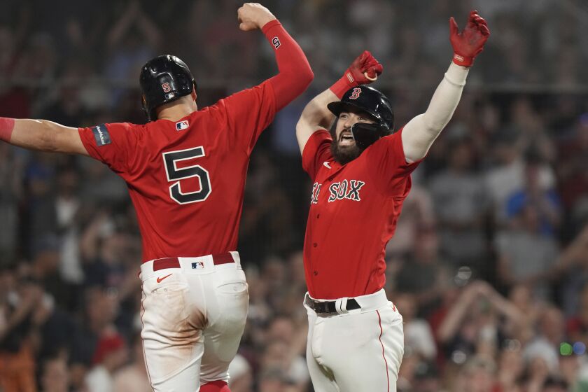 Boston Red Sox's Connor Wong, right, celebrates with Enrique Hernandez (5) after hitting a two-run home run against the Cincinnati Reds during the eighth inning of a baseball game Thursday, June 1, 2023, in Boston. (AP Photo/Steven Senne)