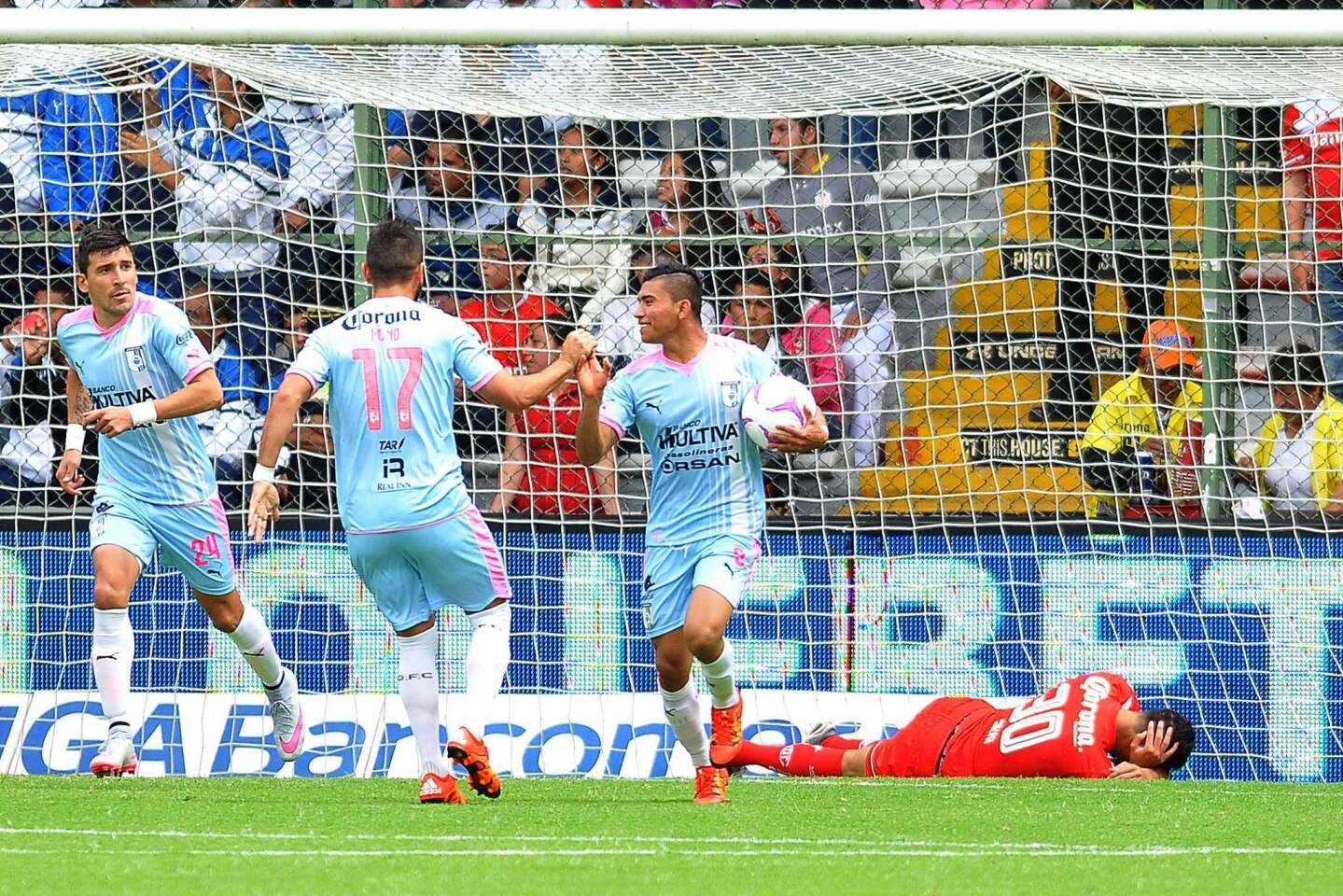 Queretaro's Orbelin Pineda (R) celebrates with teammates Mario Osuna (C) and Edgar Benites (L) after scoring a goal against Toluca during their Mexican Apertura tournament football match at the Nemesio Diez stadium on October 18, 2015, in Toluca, Mexico. AFP PHOTO/MARIA CALLSMARIA CALLS/AFP/Getty Images ** OUTS - ELSENT, FPG, CM - OUTS * NM, PH, VA if sourced by CT, LA or MoD **