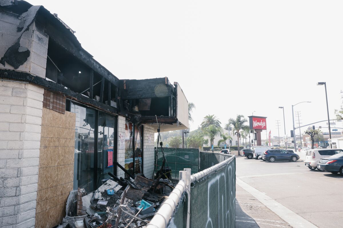 A side view of a string of businesses destroyed by fire.