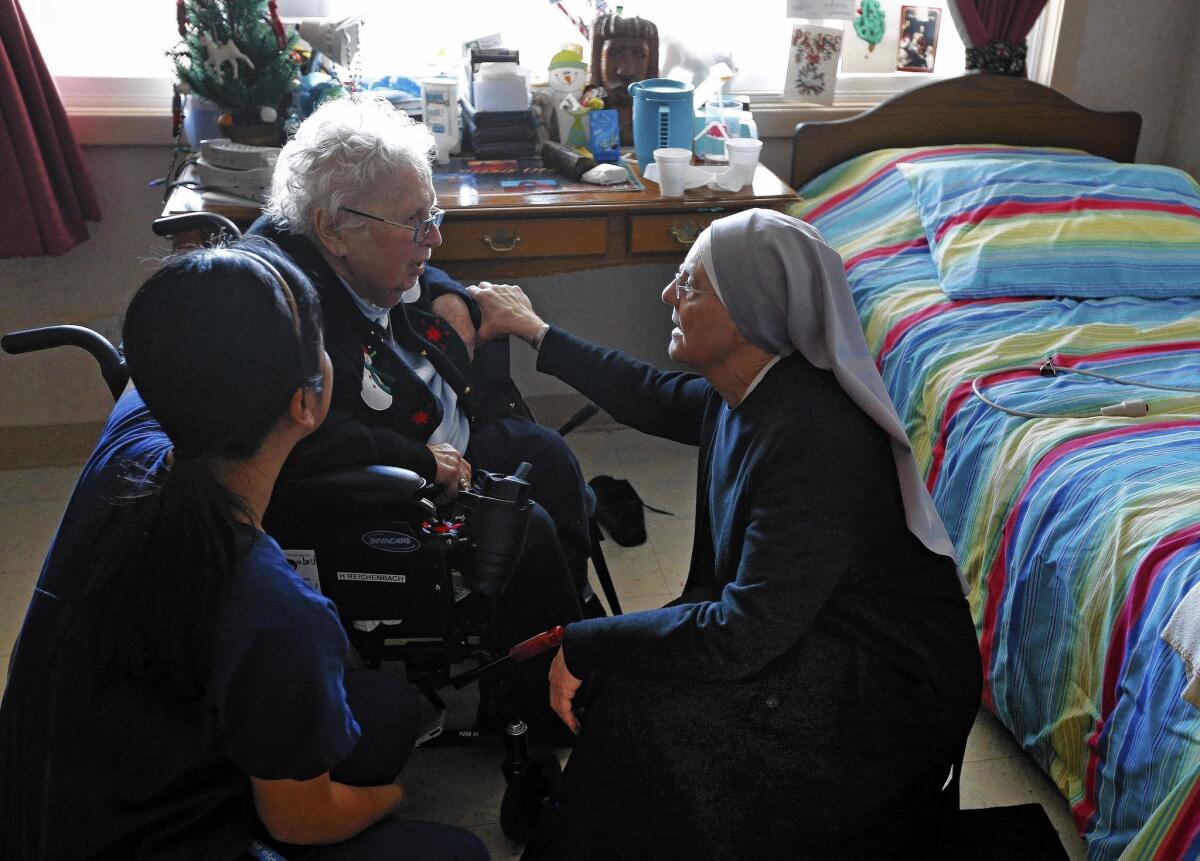 Mother Patricia Mary, right, and nurse Friary Nguyen visit Helen Reichenbach in her room at the Mullen Home for the Aged in Denver, run by the Little Sisters of the Poor. Justice Sonia Sotomayor temporarily blocked the Obama administration’s contraceptive mandate at the nuns’ request.