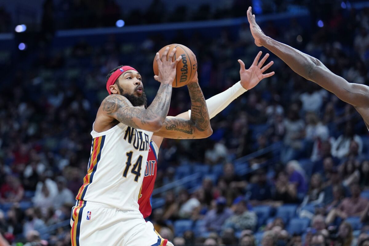 New Orleans Pelicans forward Brandon Ingram (14) drives to the basket in the second half of an NBA basketball game against the Detroit Pistons in New Orleans, Friday, Dec. 10, 2021. (AP Photo/Gerald Herbert)