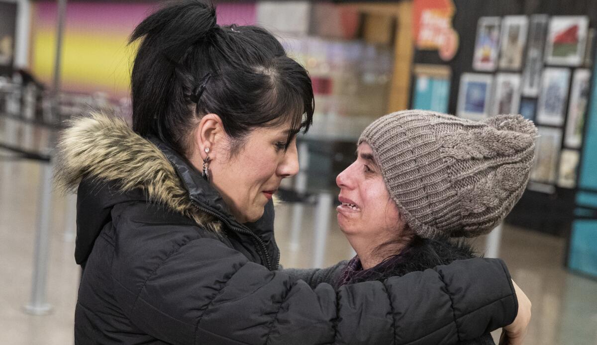 Nadia Mousavi comforts Saltanat Moradi after her arrival in Seattle.