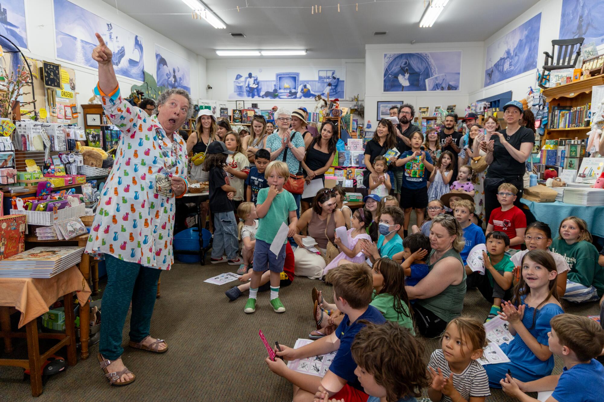 Maureen Palacios, owner of Once Upon to Time Bookstore, points to Pippi the cat that makes him descent