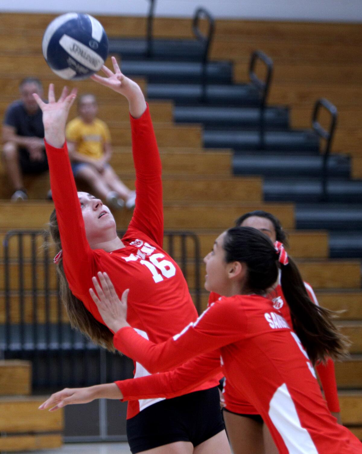 Burroughs High School volleyball player Milana Abrahamian sets the ball in away game vs. Crescenta Valley High School, in La Crescenta on Thursday, Sept. 12, 2019.