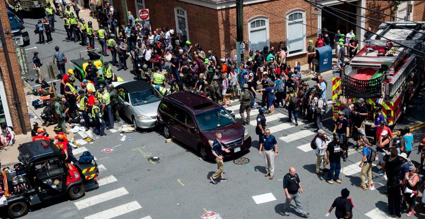 People receive first aid after a car ran into a crowd of protesters in Charlottesville, VA.