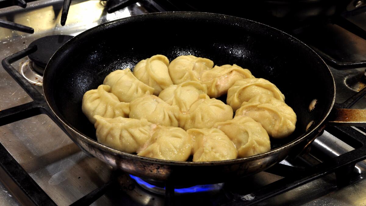 Homemade dumplings like these pan-fried pork and cucumber potstickers are prized for their chewy texture and generous fillings.