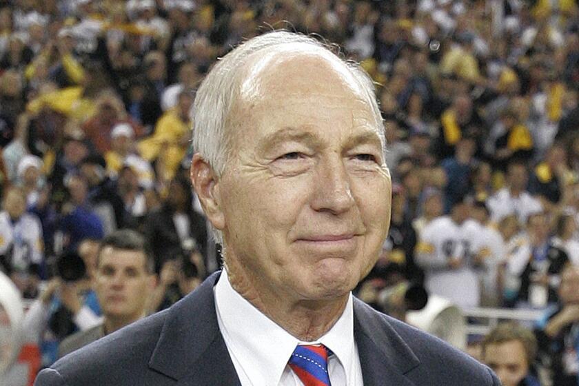 FILE - In this Feb. 5, 2006, file photo, former Green Bay Packers' Bart Starr carries in the Vince Lombardi Trophy following the Super Bowl XL football game between the Seattle Seahawks and Pittsburgh Steelers, in Detroit. The Steelers won, 21-10. Bart Starr, the Green Bay Packers quarterback and catalyst of Vince Lombardi's powerhouse teams of the 1960s, has died. He was 85. The Packers announced Sunday, May 26, 2019, that Starr had died, citing his family. He had been in failing health since suffering a serious stroke in 2014. (AP Photo/Michael Conroy, File)