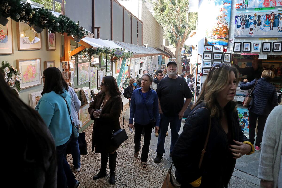 Visitors explore the grounds at the Sawdust Art Festival during Winter Fantasy.