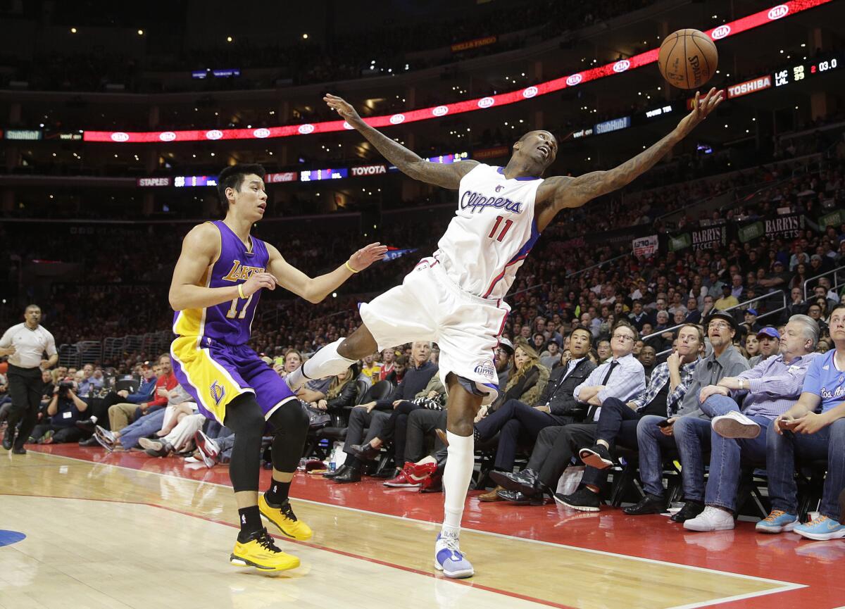 Clippers guard Jamal Crawford tries to grab a pass in front of Lakers guard Jeremy Lin during a game Tuesday at Staples Center.