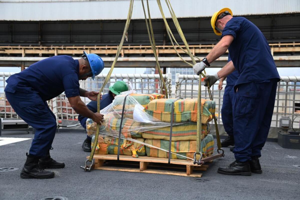 Crew of the Coast Guard Cutter Kimball offload about 11,300 pounds of cocaine and 4,000 pounds of marijuana