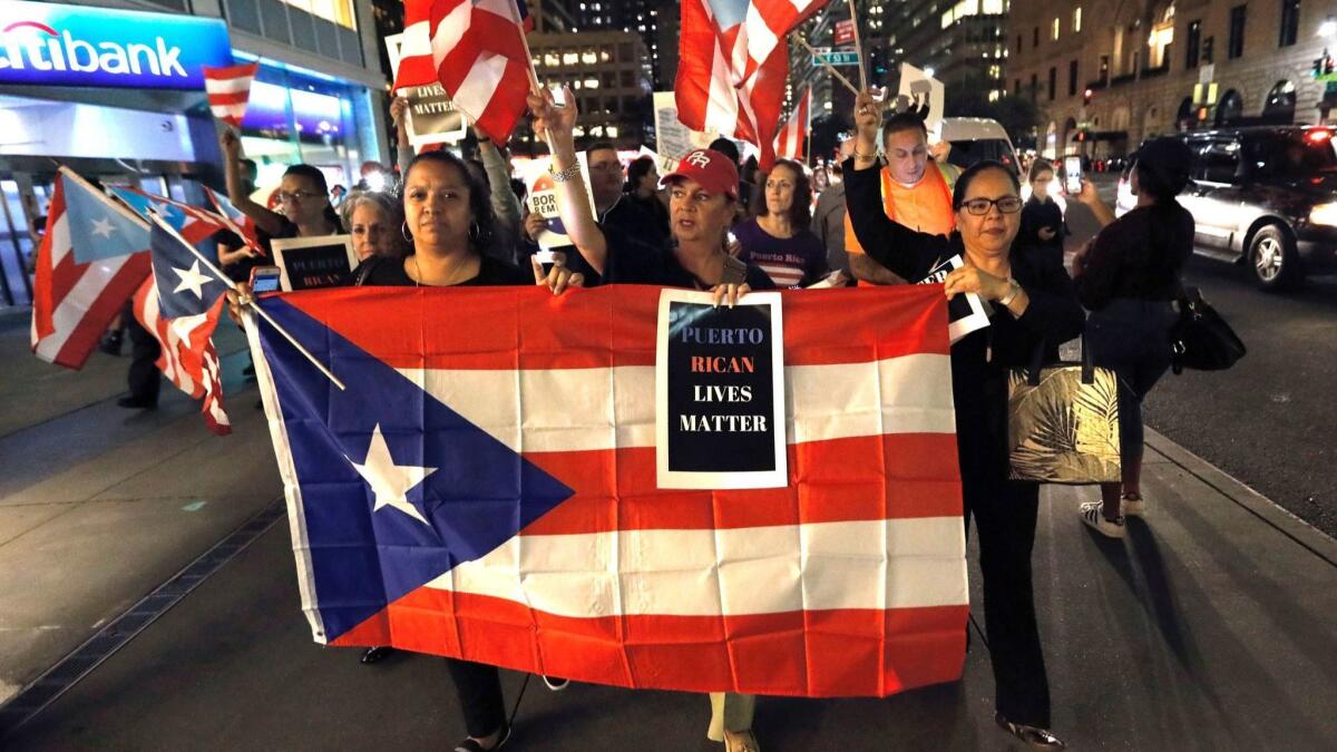 Hundreds of people march near Trump Tower in New York on Sept. 20 to bring attention to the nearly 3,000 deaths in Puerto Rico caused by Hurricane Maria.