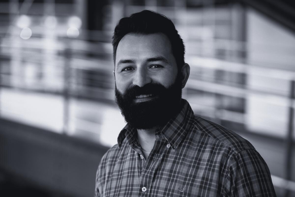 A bearded man in a plaid shirt