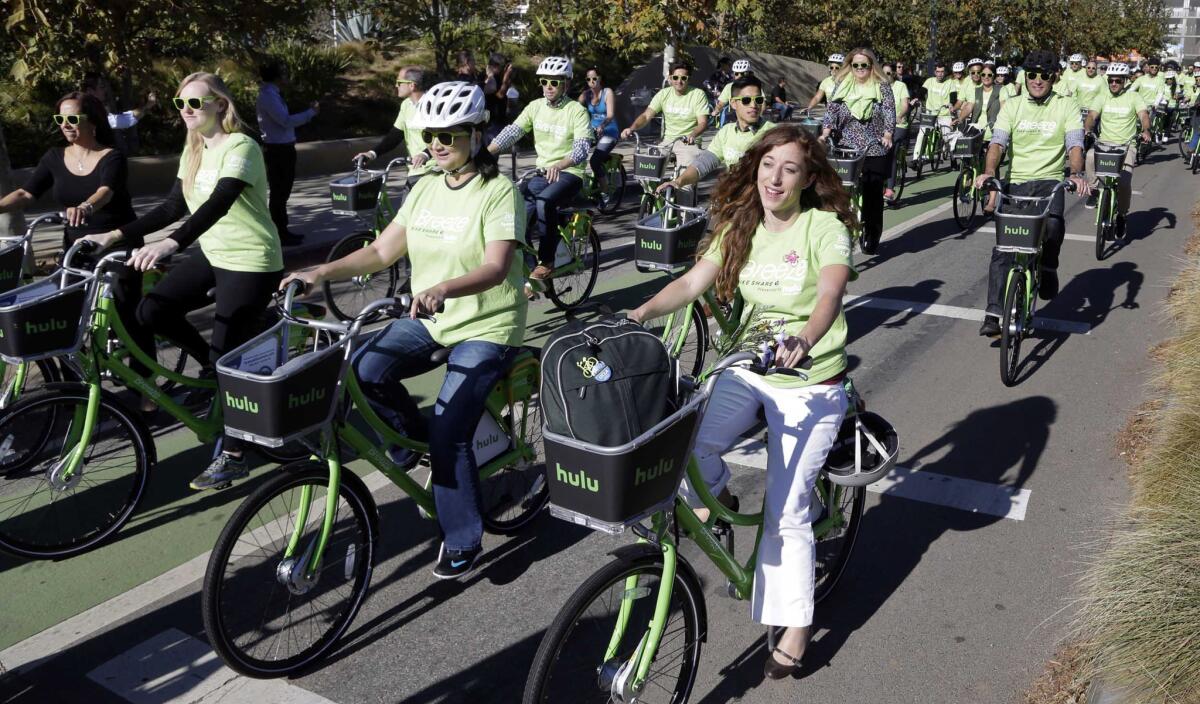 Riders test out new bicycles as part of a bike-share program in Santa Monica on Nov. 12, 2015.