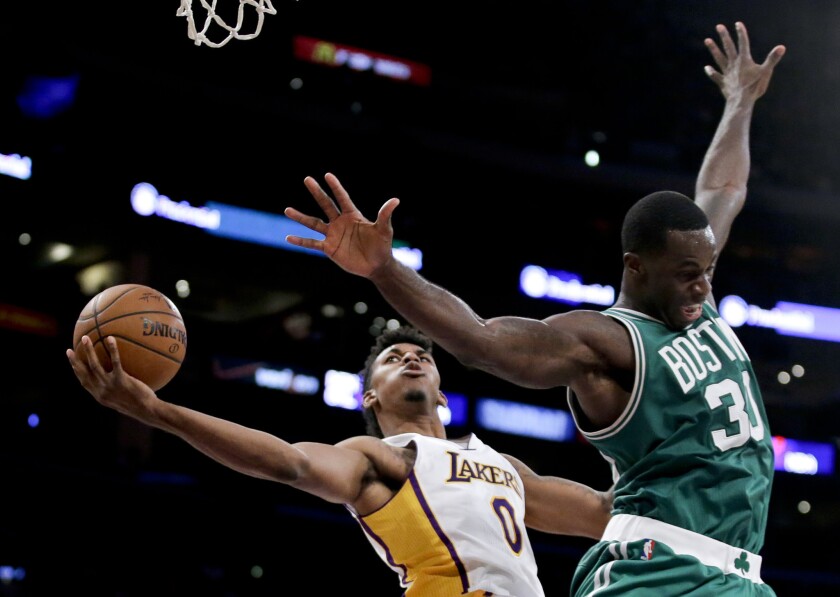 Lakers forward Nick Young scores against Celtics forward Brandon Bass during a game at Staples Center on Feb. 22.