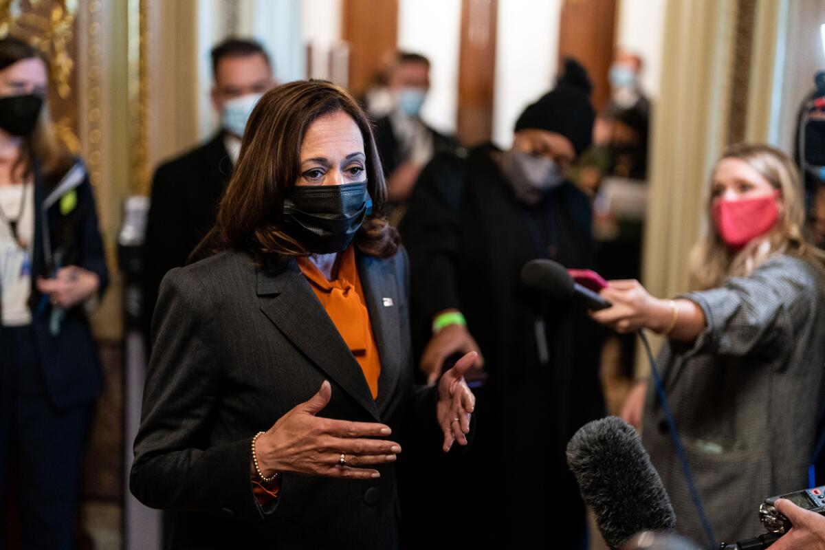 Vice President Kamala Harris speaks with reporters at the Capitol.