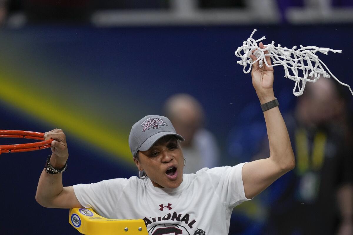FILE - South Carolina head coach Dawn Staley cuts the net after a college basketball game in the final round of the Women's Final Four NCAA tournament against UConn Sunday, April 3, 2022, in Minneapolis. On Wednesday night, Oct. 12, 2022, Staley will be on the receiving end of more accolades. Staley will accept the Billie Jean King Leadership Award at the Women’s Sports Foundation's Annual Salute to Women in Sports.(AP Photo/Charlie Neibergall, File)