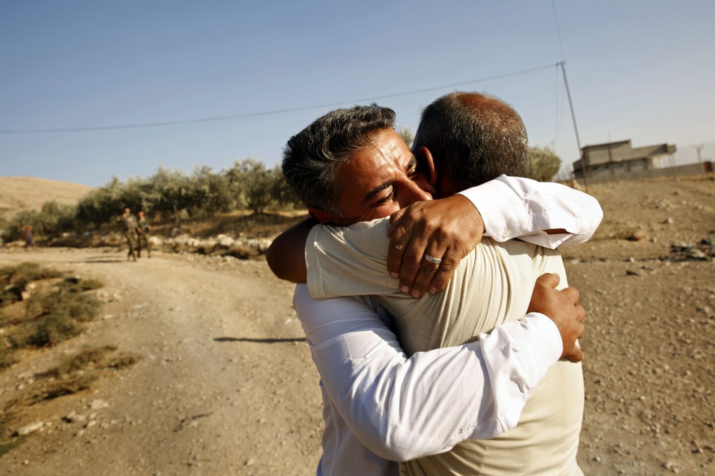 In the village of Faziliya, recently liberated from Islamic State, Abdul Gafur, 38, embraces his brother Mohammad Abdul Gafur, 40. The two had not seen each other since Islamic State forces took control of the village more than two years ealier.