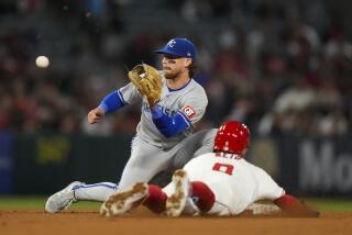 Los Angeles Angels' Zach Neto (9) steals second ahead of a throw to Kansas City Royals shortstop.