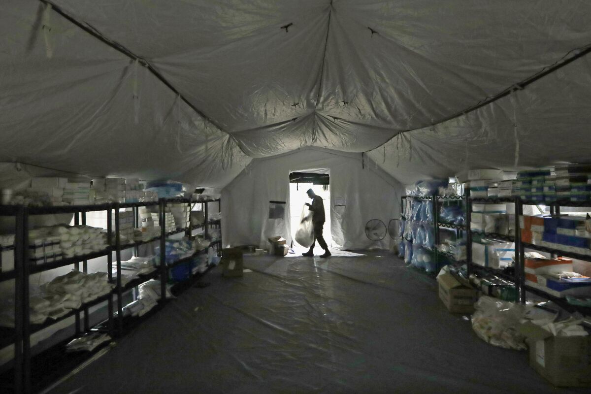A U.S. Army soldier walks in a mobile surgical unit March 31 being set up by soldiers as part of a field hospital in Seattle 