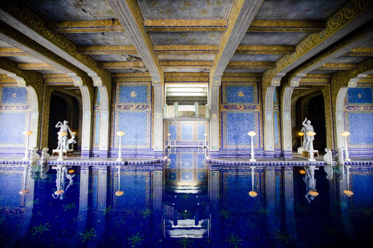 The Roman Pool at Hearst Castle has blue mosaic tile walls and white statues