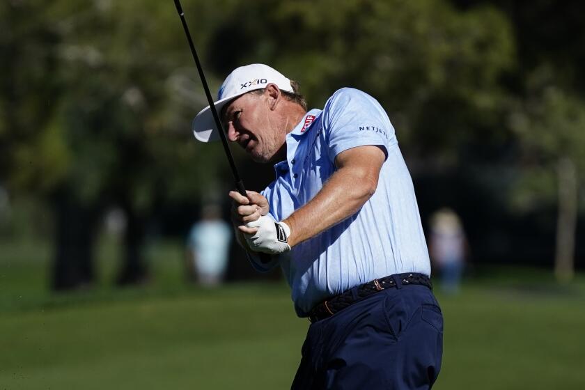 Ernie Els, of South Africa, hits his approach shot at the seventh hole during the third round.