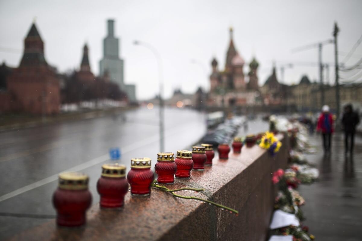 Votive candles at the place where Boris Nemtsov, the charismatic Russian opposition leader and sharp critic of President Vladimir Putin, was gunned down on Friday, Feb. 27 with St. Basil's Cathedral in the background.