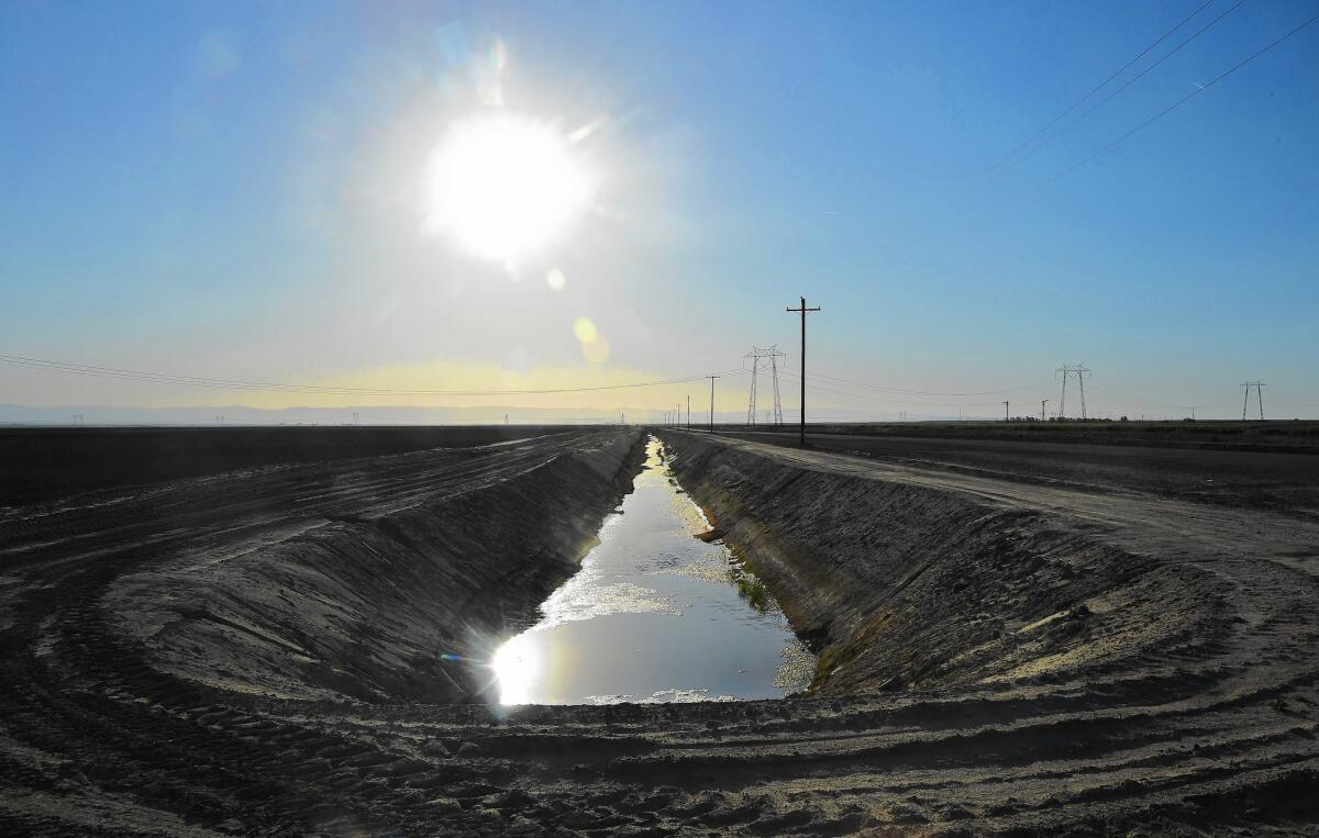 Water flows in an aqueduct amid crop fields in Kern County. The Central Valley produces more than $40 billion in crops each year, making California the biggest ag state in the U.S.