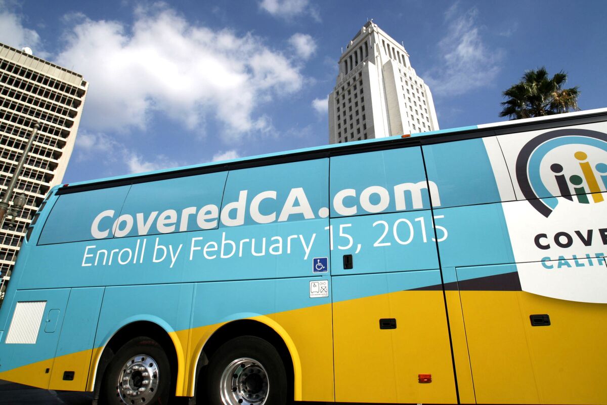 A Covered California bus departs Grand Park, in front of Los Angeles City Hall, last November. More than two-thirds of Californians uninsured before the Affordable Care Act now have coverage, a new report finds.