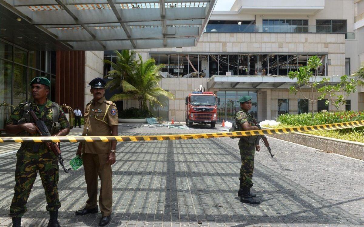 Sri Lankan security personnel guard the entrance to the Shangri-La Hotel in Colombo after it was bombed on Sunday.
