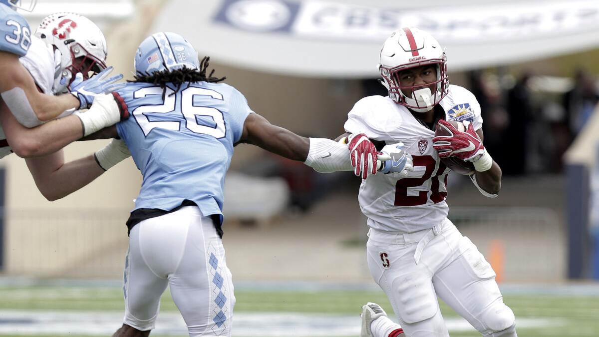 Stanford running back Bryce Love tries to evade North Carolina safety Dominiqie Green during the second quarter Friday.