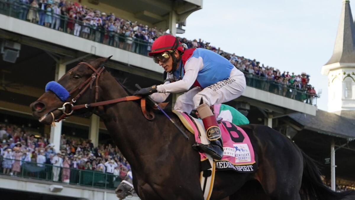 John Velazquez on Medina Spirit crosses the finish line to win the 147th running of the Kentucky Derby at Churchill Downs.