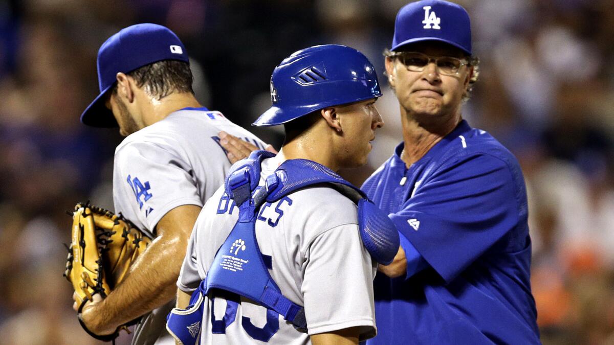The question when Dodgers Manager Don Mattingly, right, replaces a pitcher isn't who's next, it's will the reliever be effective?