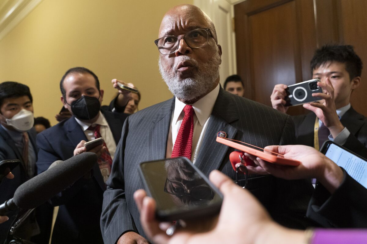 Chairman of the House select committee investigating the Jan. 6, 2021, attack on the Capitol, Rep. Bennie Thompson, D-Miss., is reflected in a cell phone as he talks with the media after a hearing of the committee, Thursday, June 16, 2022, on Capitol Hill in Washington. (AP Photo/Jacquelyn Martin)