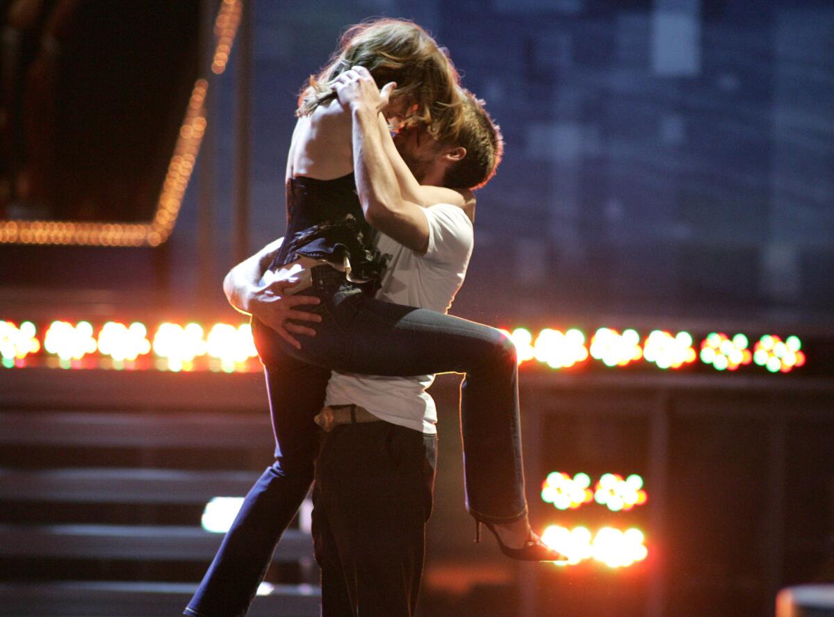Rachel McAdams and Ryan Gosling celebrate their award for best kiss at the 2005 MTV Movie Awards.
