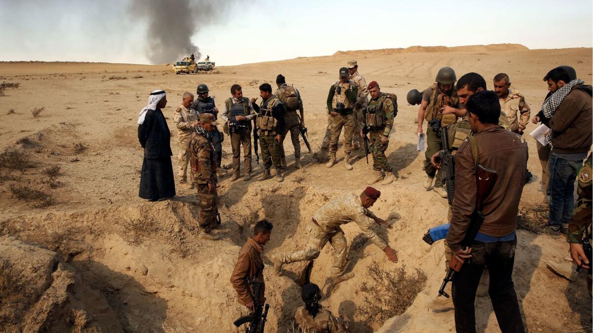 On the outskirts of the village of Hud, Iraqi soldiers visit a site where locals say Islamic State executed four or five people. Another gravesite containing many more people was in the area but soldiers said it was too dangerous to visit due to mines.