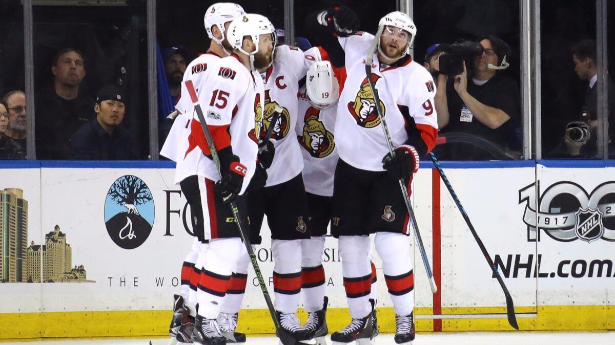 Ottawa Senators' Erik Karlsson (65) celebrates with teammates Zack Smith (15), Bobby Ryan (9), Derick Brassard (19) and Marc Methot (3) after scoring a goal against the New York Rangers during the second period, Tuesday.