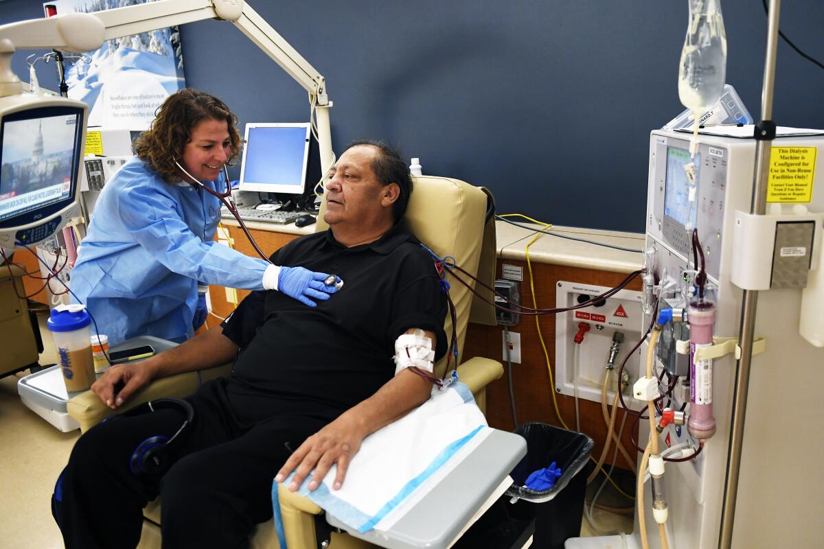 Corinna Montesano, a registered nurse, checks Bernard Trujillo's heartbeat at DaVita Lakewood Dialysis Center in Colorado last year.