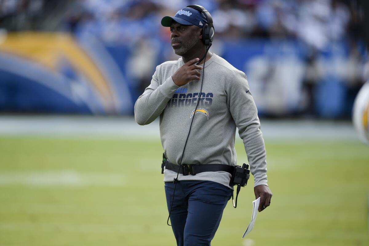 Chargers coach Anthony Lynn watches from the sideline during a game.