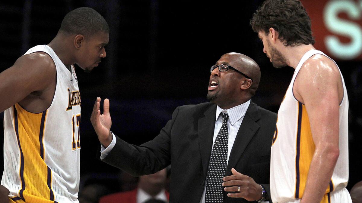 Coach Mike Brown, center, had a relatively short tenure with the Lakers despite having two 7-footers in Andrew Bynum, left, and Pau Gasol.