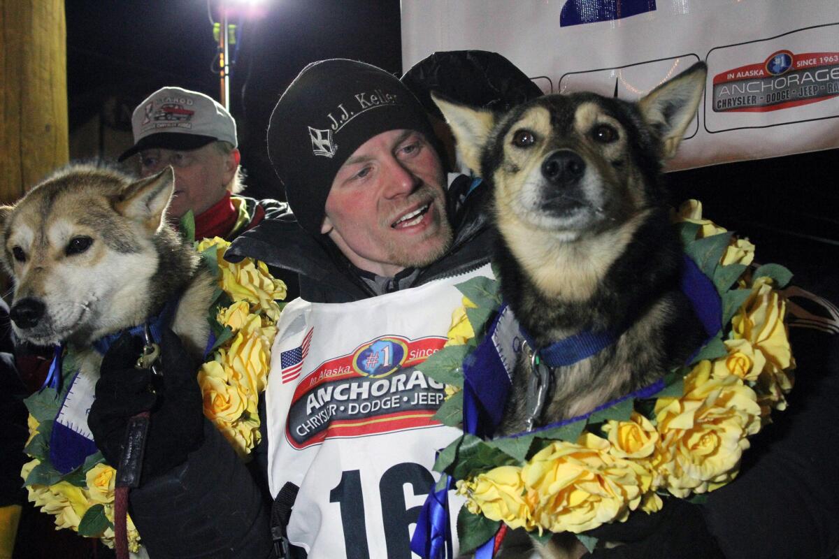 Dallas Seavey with his lead dogs Reef, left, and Tide after finishing first in the Iditarod Trail Sled Dog Race on Tuesday in Nome, Alaska.