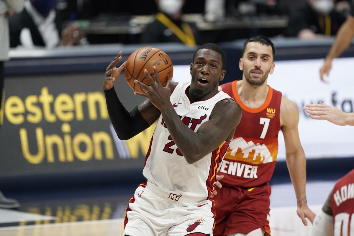 Miami Heat guard Kendrick Nunn controls the ball in front of Denver Nuggets guard Facundo Campazzo during a game in April.